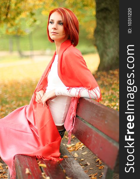 Young girl relaxing in autumn park. Young girl relaxing in autumn park