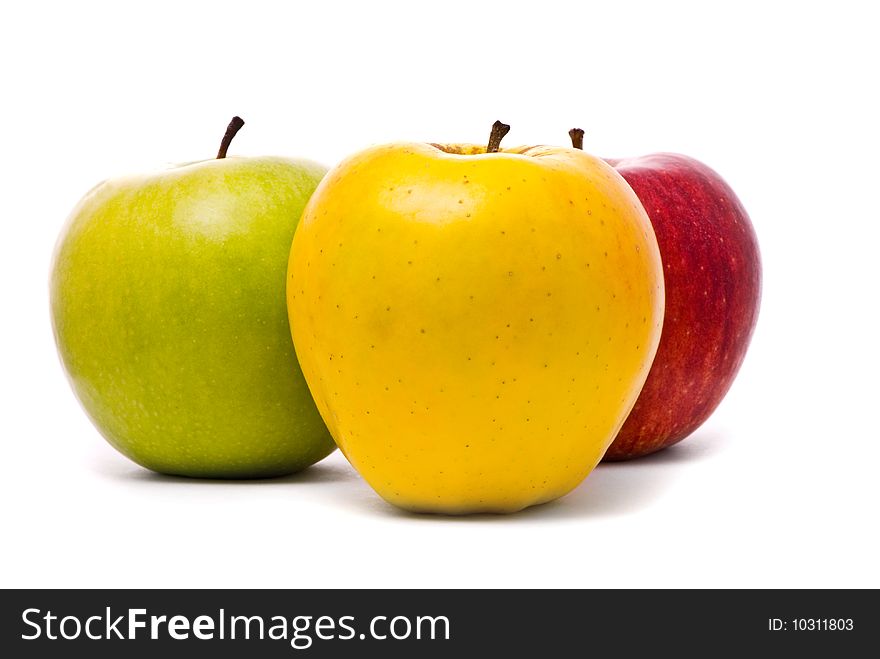 Red, yellow and green fresh apples on studio white