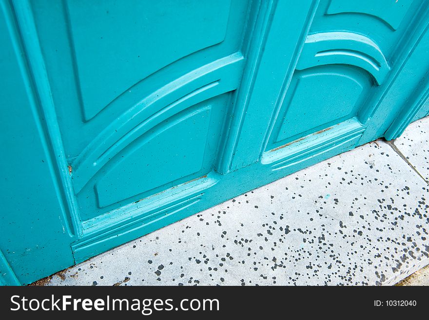 Close up of a blue door and the step with raindrops. Close up of a blue door and the step with raindrops