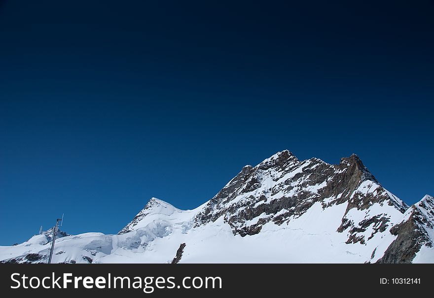 Summit of snow mountain Jungfrau in Switzerland in summer - Top of Europe. Summit of snow mountain Jungfrau in Switzerland in summer - Top of Europe