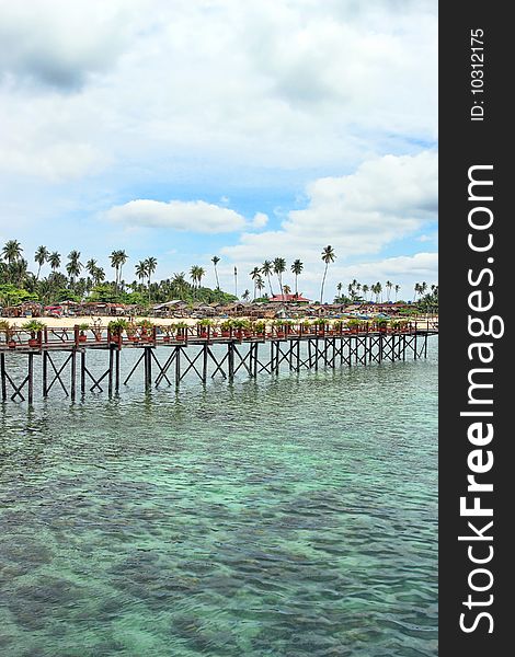 Wooden bridge built above water at Mabul Island.