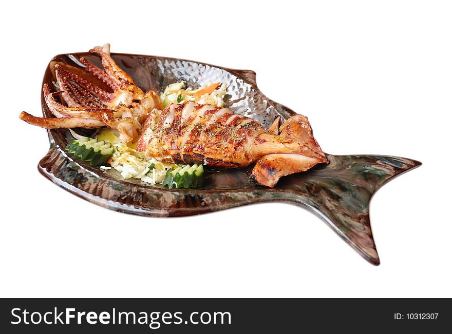 Seafood - Fresh Calamari with Salad on a plate shaped fish. Isolated on White Background