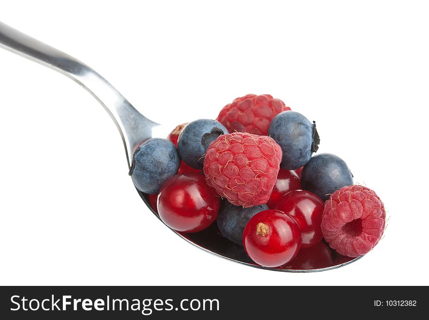 Fresh berries in spoon isolated over white