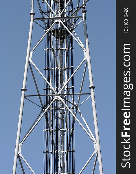 Part of a grey radio tower. Metal structure.