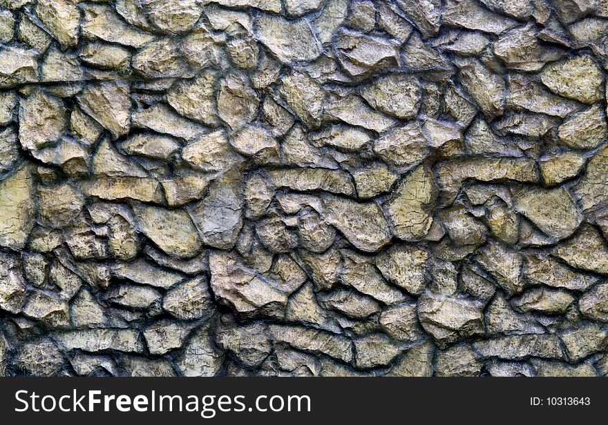 Facing of a wall of the city park, executed from a natural natural stone