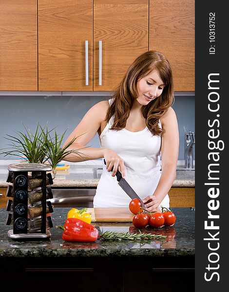 Woman cooking organic food in a modern kitchen. Woman cooking organic food in a modern kitchen