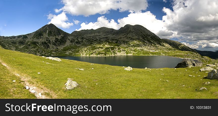 The beautiful lake Bucura in the middle of the Retezat mountain range -panorama. The beautiful lake Bucura in the middle of the Retezat mountain range -panorama