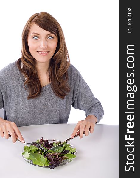 Woman eating a salad in a modern kitchen