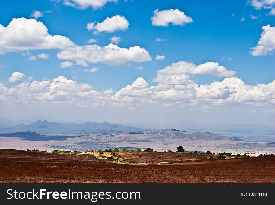 Landscape of farmland and hills with blue sky