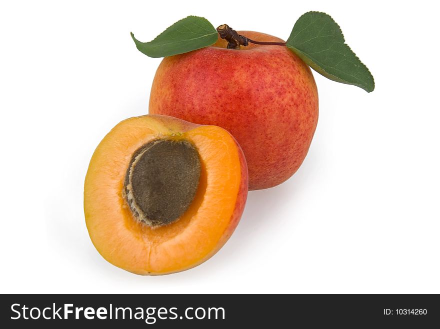 Freshly apricots with leaves on white background.
