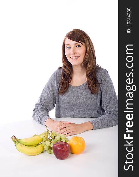 Woman eating fruit in a modern kitchen. Woman eating fruit in a modern kitchen