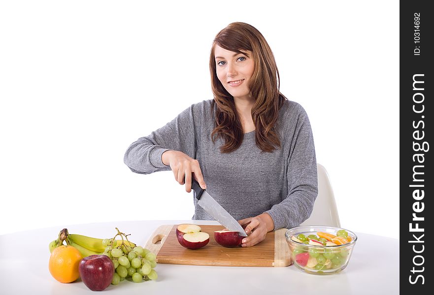 Woman cutting an apple for a fruit salad