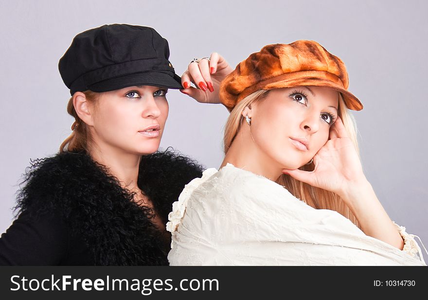 Happy beautiful young women with caps