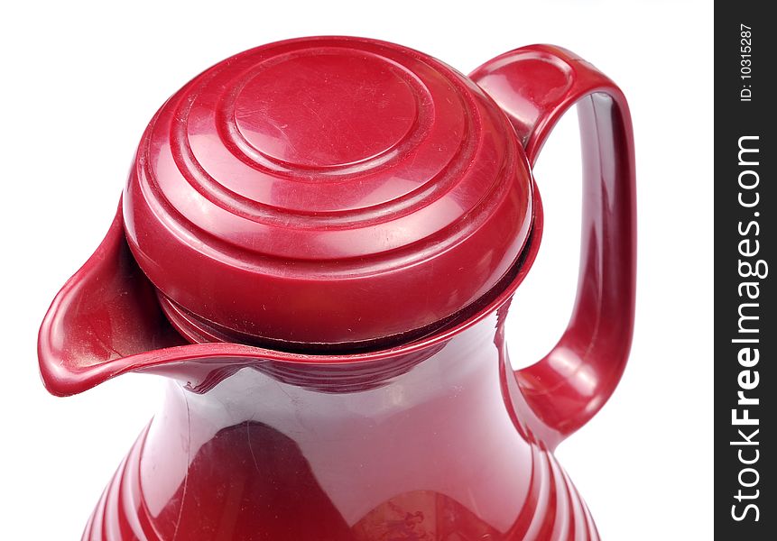 Closeup shot of cherry colored plastic kettle.