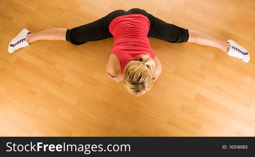 Beautiful blond women exercising on the floor