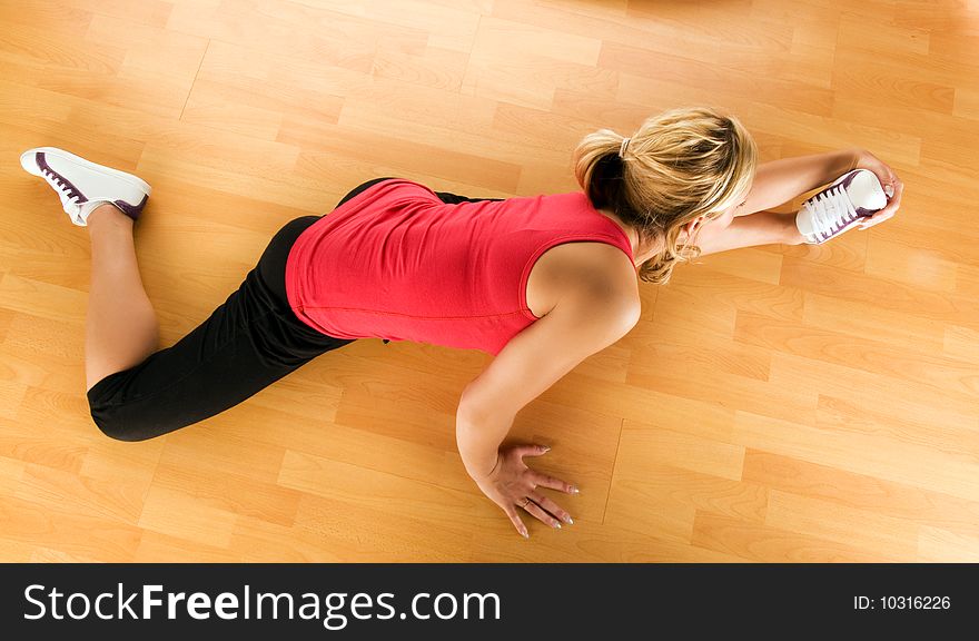 Beautiful blond women exercising on the floor