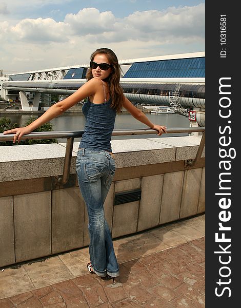 Girl standing on embankment in city