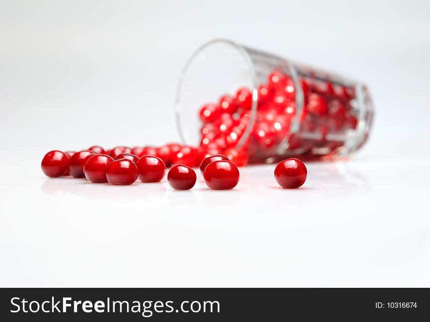 Juicy, big and sweet cherries in high glass on white background
