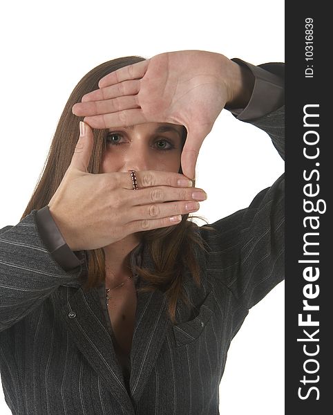 Beautiful brunette businesswoman in business suit  making a frame with her hands on white background. Not isolated