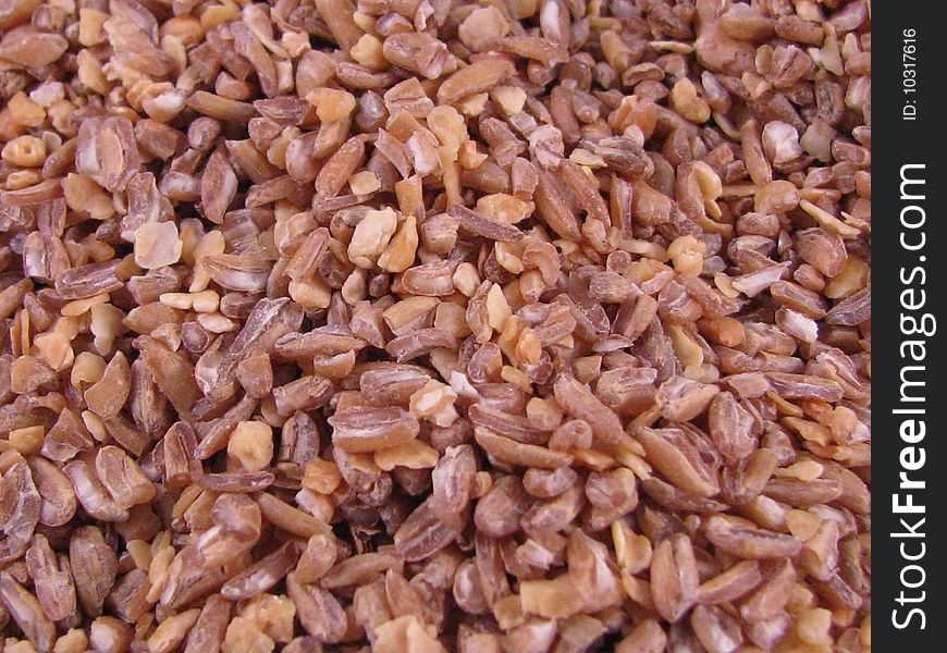 A close-up macro image of bulgur wheat grains. A close-up macro image of bulgur wheat grains.