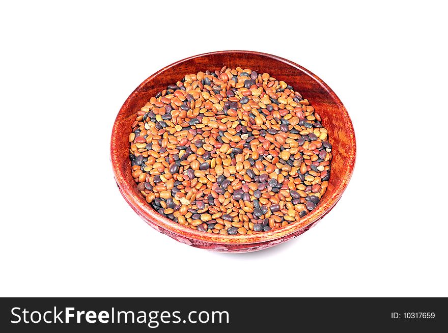 Lentils in wooden bowl isolated on white background.