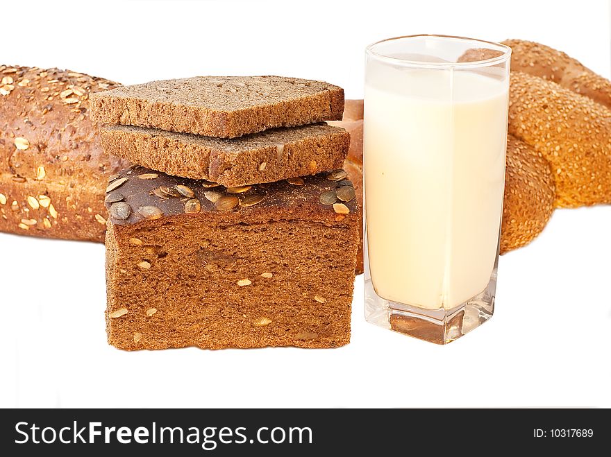 Different bread arranged on table close up with milk. Different bread arranged on table close up with milk