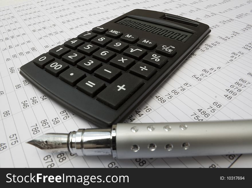 Calculator and pen on a white background. Calculator and pen on a white background