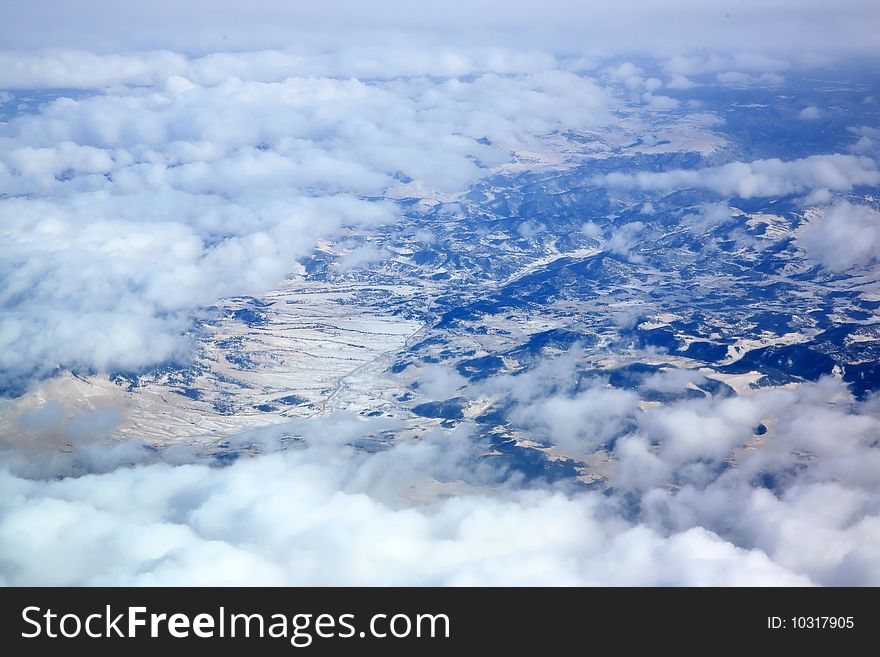 Snow covered mountains with broken clouds