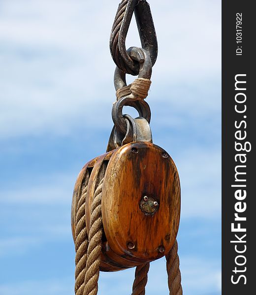 Up close of wooden block and ship rigging. Up close of wooden block and ship rigging