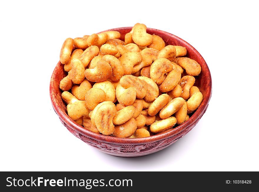 Cashew-nut shaped biscuits in wooden bowl.