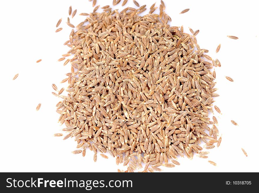 Heap of cumin isolated on white background. Heap of cumin isolated on white background.