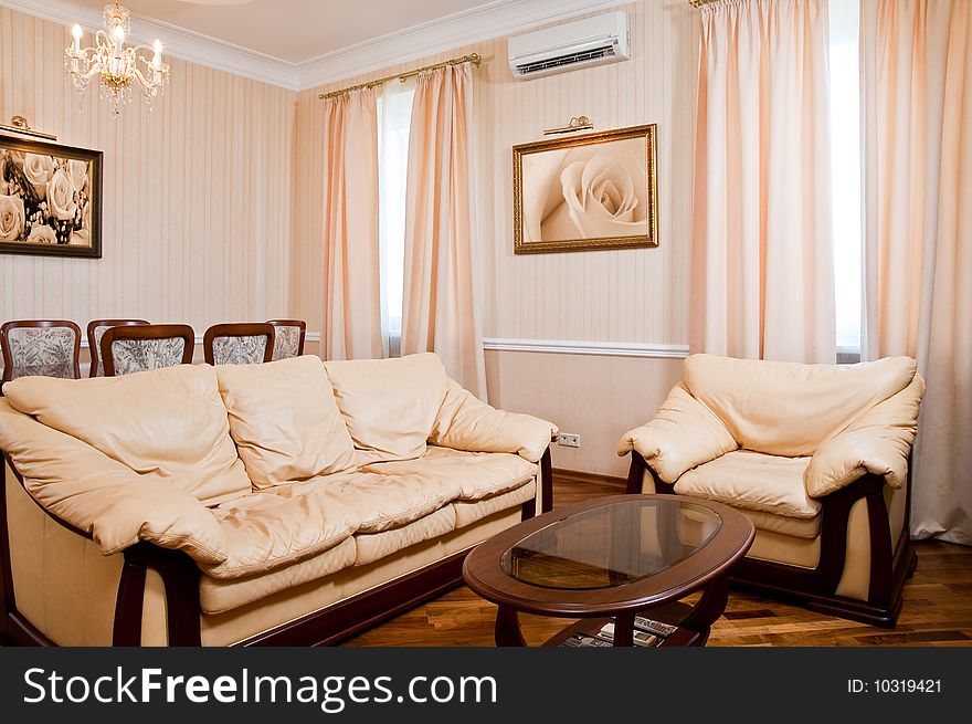 Modern furnished luxury living room. Photos in the frames made by the author