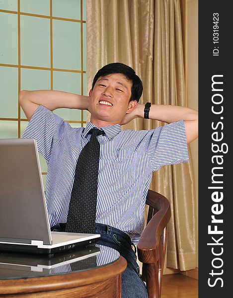 Businessman working with laptop and shows the OK sign - successful manager in the office with notebook