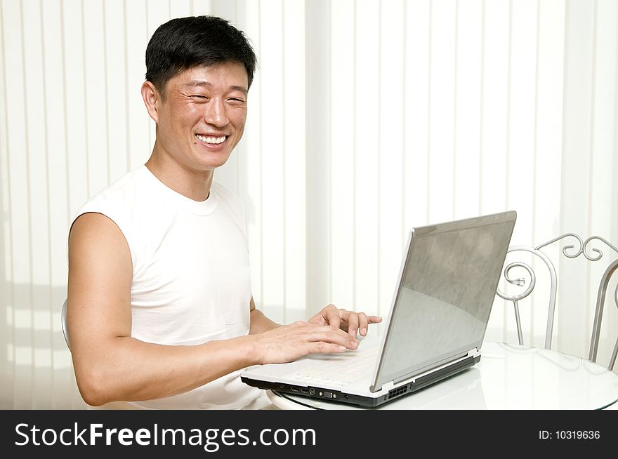 Businessman working with laptop and shows the OK sign - successful manager in the office with notebook