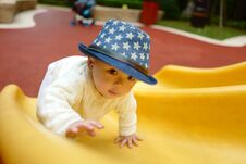 Baby On The Playground Slide Royalty Free Stock Photo