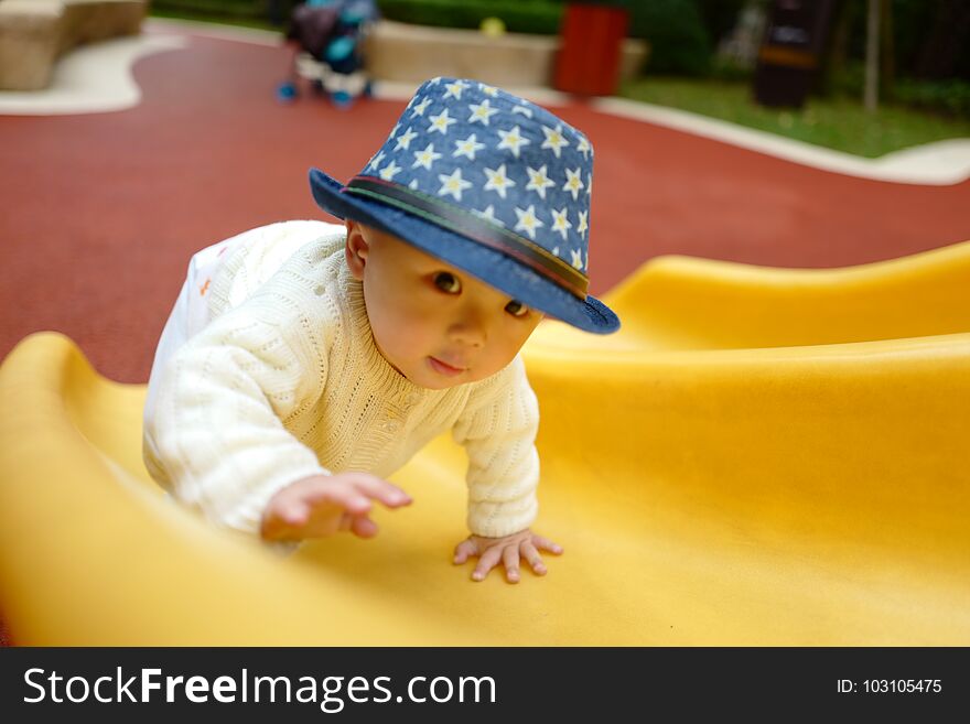 Happy little boy on the playground slide. Happy little boy on the playground slide
