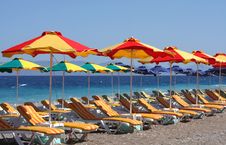 Beach With Beds And Umbrellas Royalty Free Stock Photo