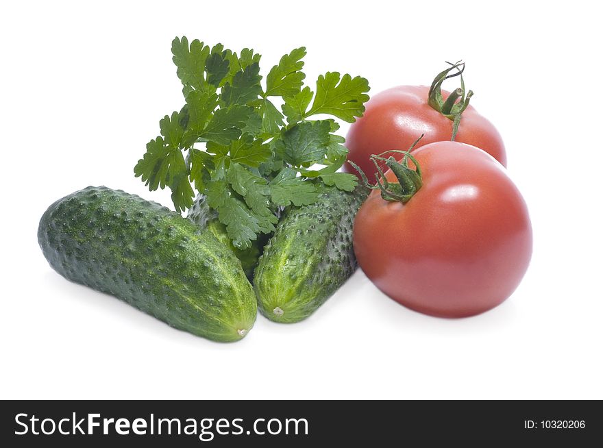 Cucumbers, tomatoes, parsley. The image on a white background.