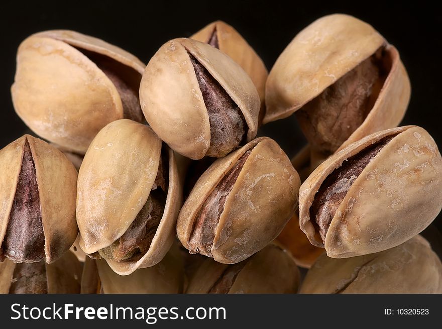 Pistachio nuts on a black background