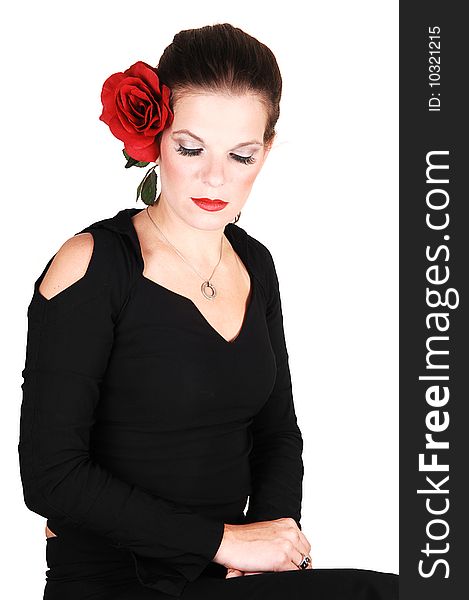 Young light red haired woman in an black dress sitting in the studio whit a 
red rose in her hair, for white background. Young light red haired woman in an black dress sitting in the studio whit a 
red rose in her hair, for white background.