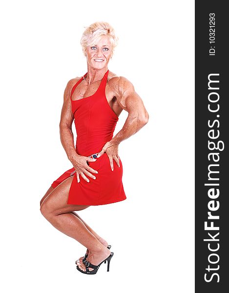 A strong blond woman in an red dress and high heels shooing her muscular body over white background. A strong blond woman in an red dress and high heels shooing her muscular body over white background.