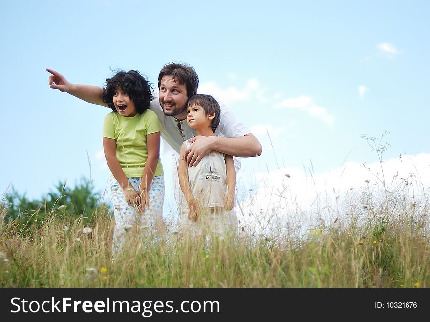 Father, daughter and son in nature