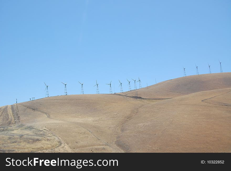 Wind mills on freeway side in california. Wind mills on freeway side in california
