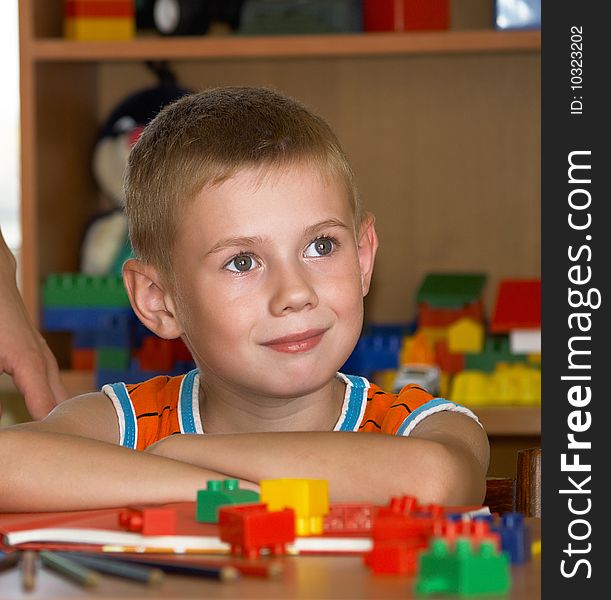 The boy of 7 years is engaged in a children's room