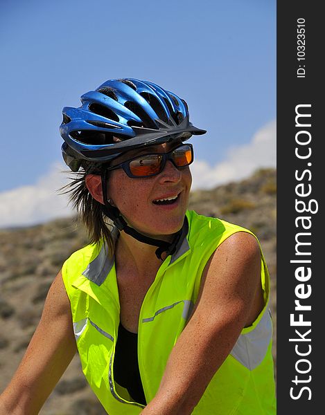 Female Cyclist Riding through Nevada Desert on Cross Country Adventure. Female Cyclist Riding through Nevada Desert on Cross Country Adventure