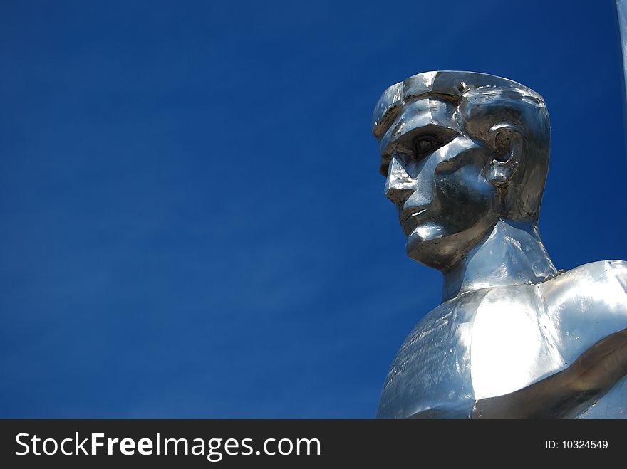 Metal sculpture of a hero with a blue sky on background. Metal sculpture of a hero with a blue sky on background