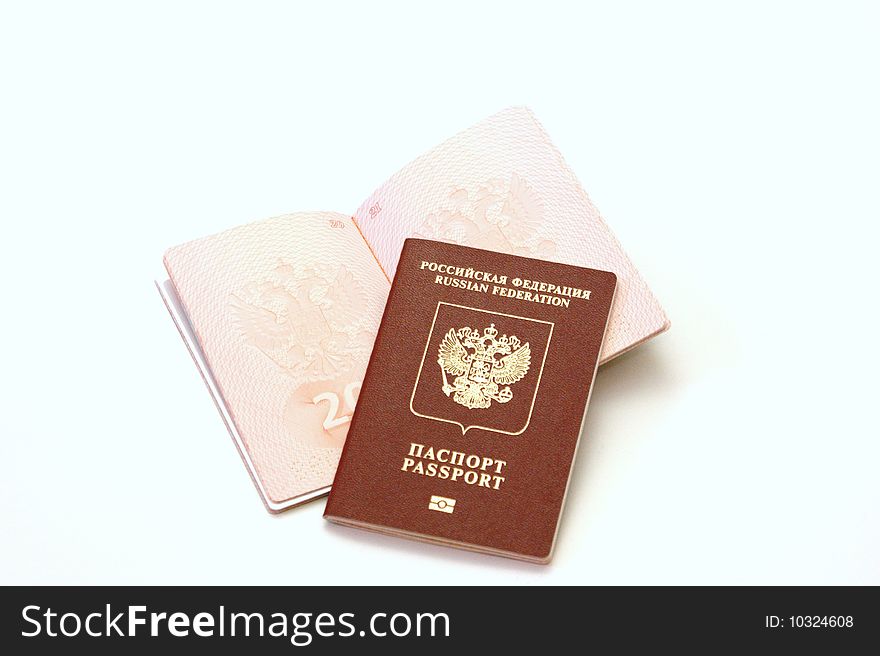 Three passports for travel abroad on a white background are removed by close up