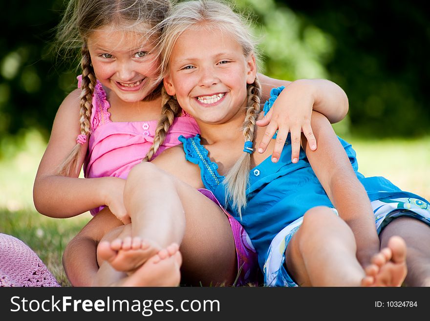 Two little girls in fresh colors in the park. Two little girls in fresh colors in the park