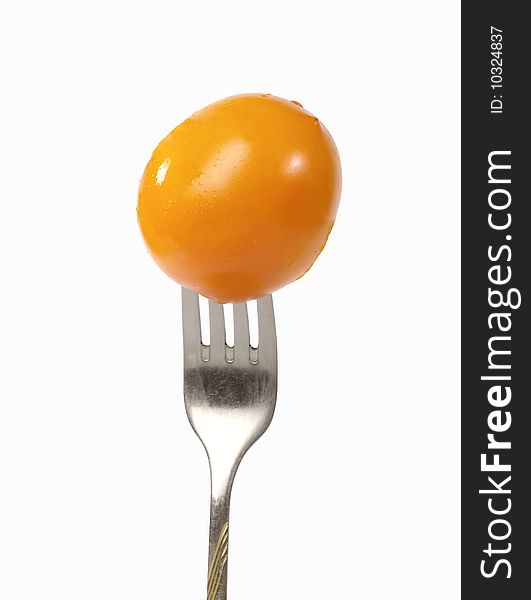 Fresh Yellow Tomato On The Fork.