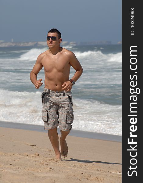 A young men running on the beach